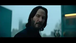 man with beard in suit in cityscape — John Wick: Chapter 4