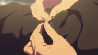 hands tying green string — Your Name