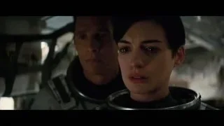 man and woman in spacesuits in space station — Interstellar