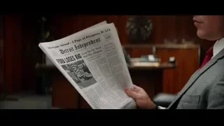 man in suit reading newspaper — Ford v Ferrari
