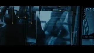 person's face on screen with blue light — Batman: The Dark Knight Rises