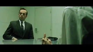 man in suit thinking at desk — The Matrix