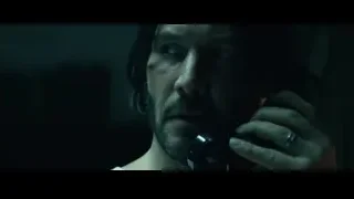 man with beard holding phone to ear — John Wick