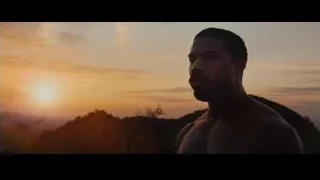 Shirtless man on hill shouting at sunset — Creed 3