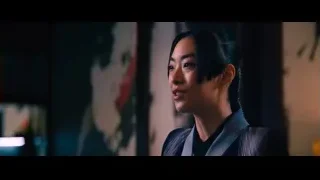 young woman's face in dimly lit room — John Wick: Chapter 4