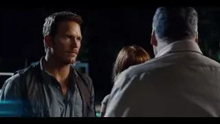 Two men talking intently near police car — Jurassic World