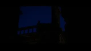 silhouette on stone balcony at night — Batman: The Dark Knight Rises