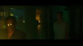 two men in dimly lit room with city view — Whiplash