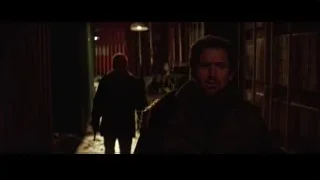 man standing in dimly lit hallway — Batman