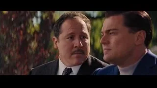 Two men in suits engaged in conversation outdoors — The Wolf Of Wall Street