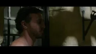 man in prison cell with bloody face — Gladiator 2