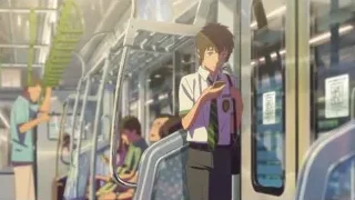 young man on subway looking at phone — Your Name