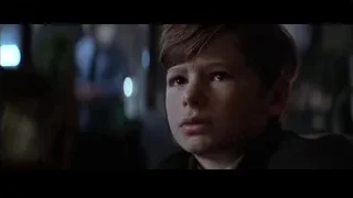 serious young man in suit in dim room — Batman
