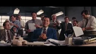 Men in office with one deep in thought — The Wolf Of Wall Street