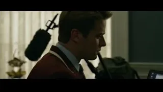 Young man in suit with microphone — The Social Network