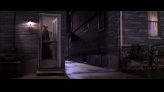 man walking on sidewalk in front of brick building — Spider Man 2