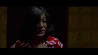 Woman in red striped shirt in dimly lit room — Bruce Lee: Enter The Dragon