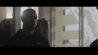 Man in Nike jacket in gym looking at skyline — Creed 2