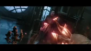 Man in purple robe holding glowing lights — Doctor Strange 2