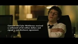 young man looking at laptop at desk — The Social Network