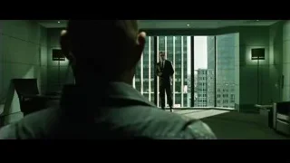 man in suit looking at cityscape — The Matrix