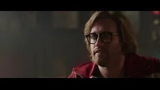 man's serious face in dim room — Deadpool
