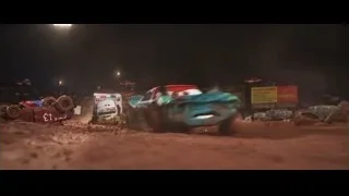 monster trucks racing on dirt track at night — Cars 3