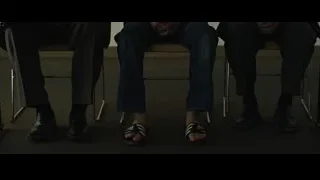 Three men sitting at courtroom table — The Social Network