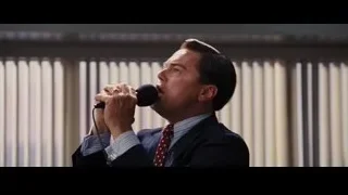Man in suit singing into microphone — The Wolf Of Wall Street