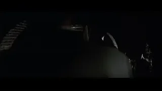 Two men in suits in dark tunnel — Batman
