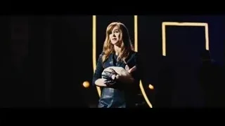 woman with blonde hair holding cat on stage — Now You See Me