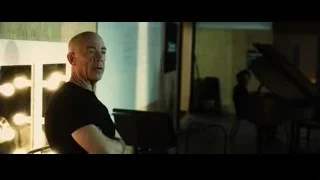 bald man thinking in dimly lit room — Whiplash