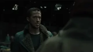 Man in green jacket in dim room — Blade Runner 2049