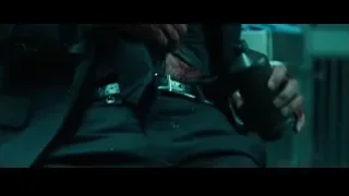 Bloody hands holding gun in dimly lit room — John Wick