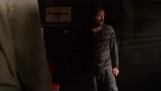 man holding gun in dimly lit room — Breaking Bad