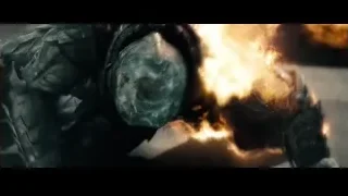 Man in armor standing by fire — Superman: Man of Steel