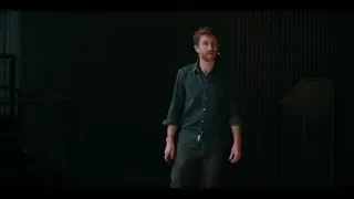 man on stage with microphone and staircase — The Social Dilemma