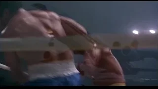 two shirtless men fighting with bats — Rocky III