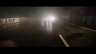 Sports car driving on wet road at night — Ford v Ferrari