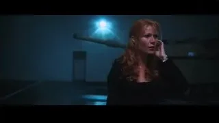 red-haired woman holding gun in dark room — Iron Man