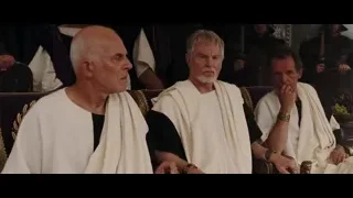 three men sitting on throne-like chair — Gladiator