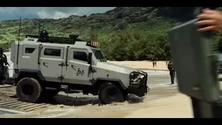 men walking on beach with military equipment — Jurassic World