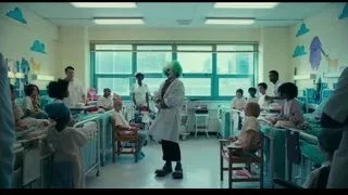 man with wig speaking to children in hospital — Joker
