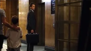 Man in suit walking down hallway — Suits