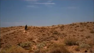 Person riding dirt bike quickly on hill — Breaking Bad