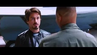 Tony Stark conversing with man in uniform — Iron Man