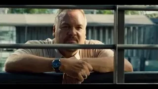 man leaning on railing in outdoor setting — Jurassic World