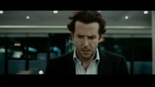 man looking at camera in dimly lit office — Limitless