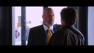 two bald men talking by city window — Iron Man