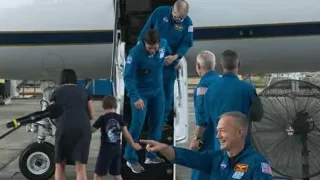 men in space suits standing by airplane — Elon Musk: Return to Space